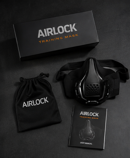 Black AIRLOCK training mask set laid out on a dark surface, including the mask itself, branded box, black drawstring pouch, and user manual.